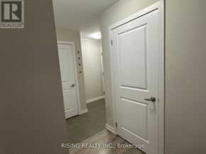 Hamilton (Stoney Creek) condo for rent - A hallway with two doors and a brokerage logo.