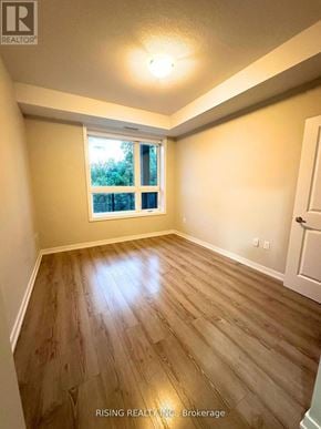 Hamilton (Stoney Creek) condo for rent - A room with wooden flooring and a window.