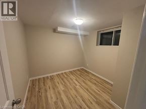 Kitchener apartment for rent - A room with wooden flooring and a window.