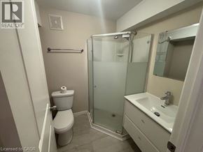Kitchener apartment for rent - A bathroom with a toilet, sink, and shower.