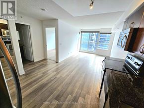 Richmond Hill (Doncrest) condo for rent - A kitchen with a black counter top and wooden floors.