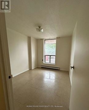Sault Ste Marie multi-family for rent - A spacious room with a window and tiled floor.