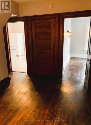 Owen Sound apartment for rent - A wooden door in a room with a white wall.