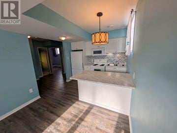 Clarington (Bowmanville) apartment for rent - A kitchen with a white countertop and a white stove top oven.