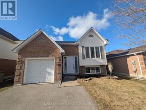 Clarington (Bowmanville) apartment for rent - A house with a white garage door is for sale.