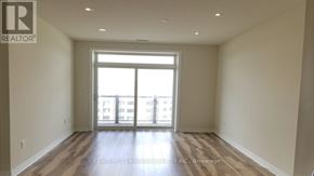 Markham (Cedarwood) condo for rent - A spacious room with a large window and wooden flooring.