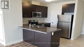 Markham (Cedarwood) condo for rent - A kitchen with a granite countertop and stainless steel appliances.