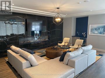 Hamilton (Beasley) condo for rent - A modern living room with a large sectional sofa and a coffee table.