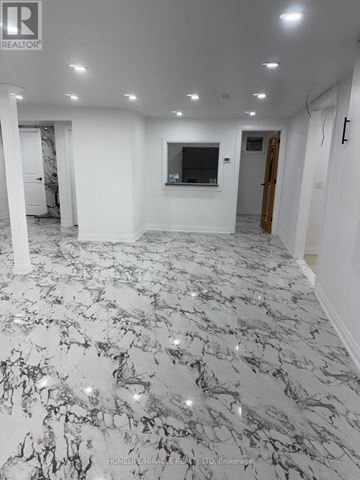Welland (Lincoln/Crowland) apartment for rent - A spacious room with marble flooring and white walls.