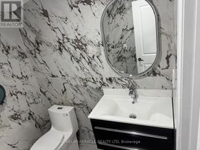 Welland (Lincoln/Crowland) apartment for rent - A bathroom with marble wallpaper and a white sink.