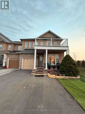 Vaughan (Vellore Village) townhouse for rent - A bedroom with a metal frame bed and wooden flooring.