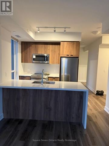 Mississauga (Creditview) condo for rent - A modern kitchen with a wooden countertop and stainless steel appliances.