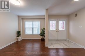 Brantford apartment for rent - A room with a white door and a window with blinds.