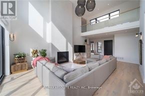 Ottawa apartment for rent - A modern living room with a grey sofa and a television.