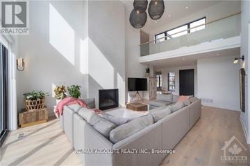 Ottawa apartment for rent - A modern living room with a grey sofa and a television.