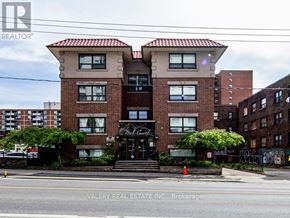 Toronto (Cabbagetown-South St. James Town) condo for rent - A building with a sign that says "Valery Real Estate Inc., Brokerage" in front of it.