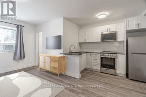 Toronto (Church-Yonge Corridor) condo for rent - A kitchen with a wooden island and stainless steel appliances.