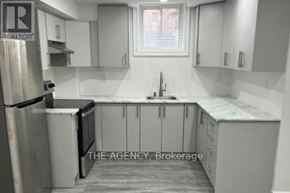 Ajax (Northeast Ajax) apartment for rent - A kitchen with white cabinets and a stainless steel refrigerator.