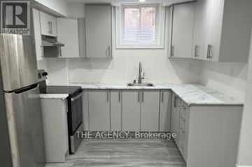 Ajax (Northeast Ajax) apartment for rent - A kitchen with white cabinets and a stainless steel refrigerator.