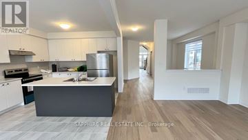 Welland (Dain City) apartment for rent - A modern kitchen with white cabinets and a central island.
