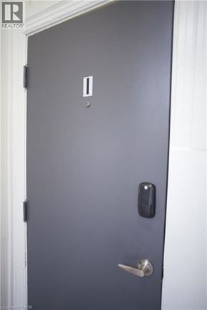Hamilton townhouse for rent - A grey door with a silver handle and a black lock.