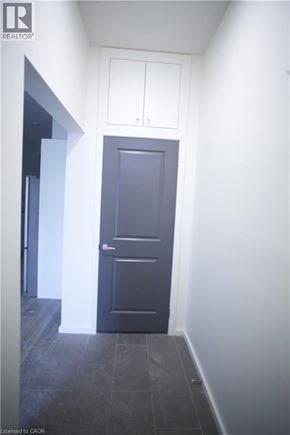 Hamilton townhouse for rent - A dark door is in a white hallway.