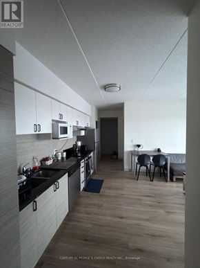 Waterloo condo for rent - A kitchen with a dining table and chairs in the background.