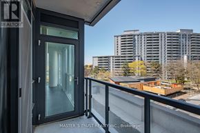 Toronto (Willowdale West) condo for rent - A balcony with a glass door overlooking a cityscape.