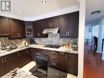 Mississauga (East Credit) apartment for rent - A kitchen with dark wood cabinets and a marble countertop.