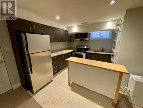 Toronto (Woodbine-Lumsden) apartment for rent - A kitchen with a refrigerator, oven, and sink.