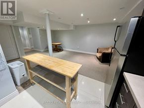 Toronto (Woodbine-Lumsden) apartment for rent - A kitchen with a table and a refrigerator.