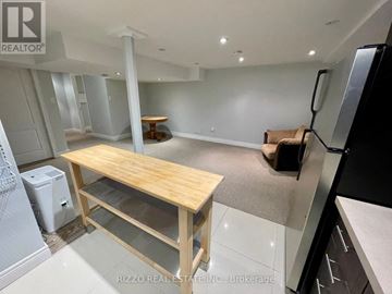 Toronto (Woodbine-Lumsden) apartment for rent - A kitchen with a table and a refrigerator.