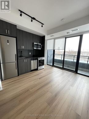Toronto (Dovercourt-Wallace Emerson-Junction) condo for rent - A modern kitchen with wooden floors and stainless steel appliances.