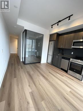 Toronto (Dovercourt-Wallace Emerson-Junction) condo for rent - A modern kitchen with wooden flooring and stainless steel appliances.