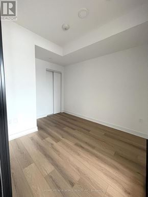Toronto (Dovercourt-Wallace Emerson-Junction) condo for rent - A room with wooden flooring and white walls.