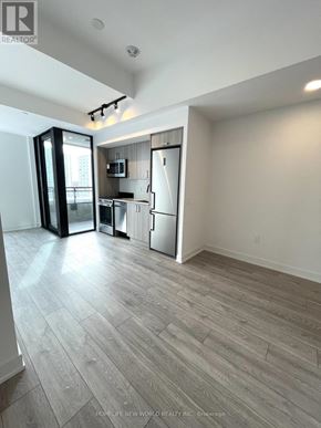 Toronto (Dovercourt-Wallace Emerson-Junction) condo for rent - A spacious kitchen with a refrigerator, microwave, and oven.