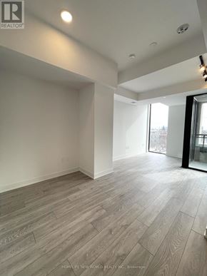 Toronto (Dovercourt-Wallace Emerson-Junction) condo for rent - A room with wooden flooring and white walls.