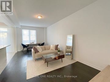 Hamilton (Meadowlands) townhouse for rent - A living room with a white couch and a coffee table.