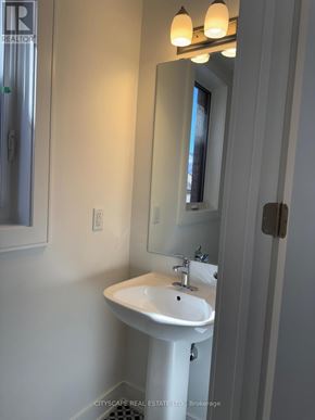 Barrie apartment for rent - A white sink in a bathroom with a mirror above it.