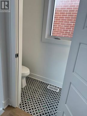Barrie apartment for rent - A bathroom with a toilet and a window.