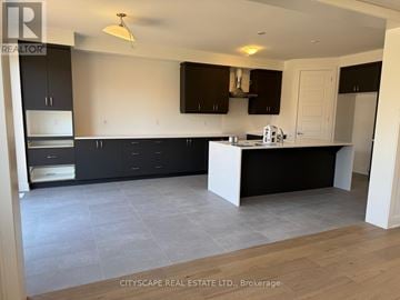 Barrie apartment for rent - A kitchen with black cabinets and a white island.