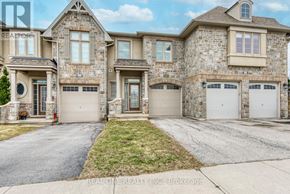Oakville (Wm Westmount) townhouse for rent - A large, two-story house with a stone facade and multiple garages.