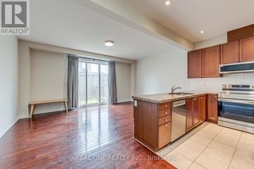 Oakville (Wm Westmount) townhouse for rent - A kitchen with wooden cabinets and a stainless steel oven.