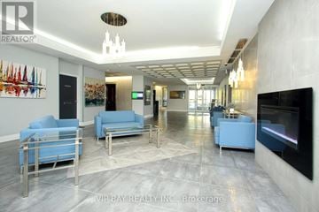 Richmond Hill (North Richvale) condo for rent - A spacious living room with a blue couch and a television.