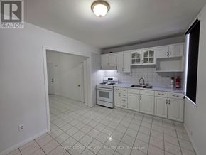Toronto (Dovercourt-Wallace Emerson-Junction) apartment for rent - A white kitchen with tile flooring and white cabinets.