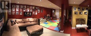 Ajax (South East) townhouse for rent - A living room with a couch and a colorful rug.