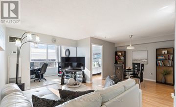 Mississauga (Cooksville) condo for rent - A well-lit living room with a large couch and a television.
