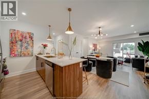 Tecumseh apartment for rent - A modern kitchen with wooden cabinets and a large island.