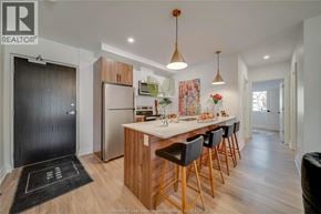 Tecumseh apartment for rent - A modern kitchen with wooden cabinets and a black mat on the floor.