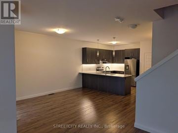 London South (South W) townhouse for rent - A kitchen with wooden floors and a countertop.